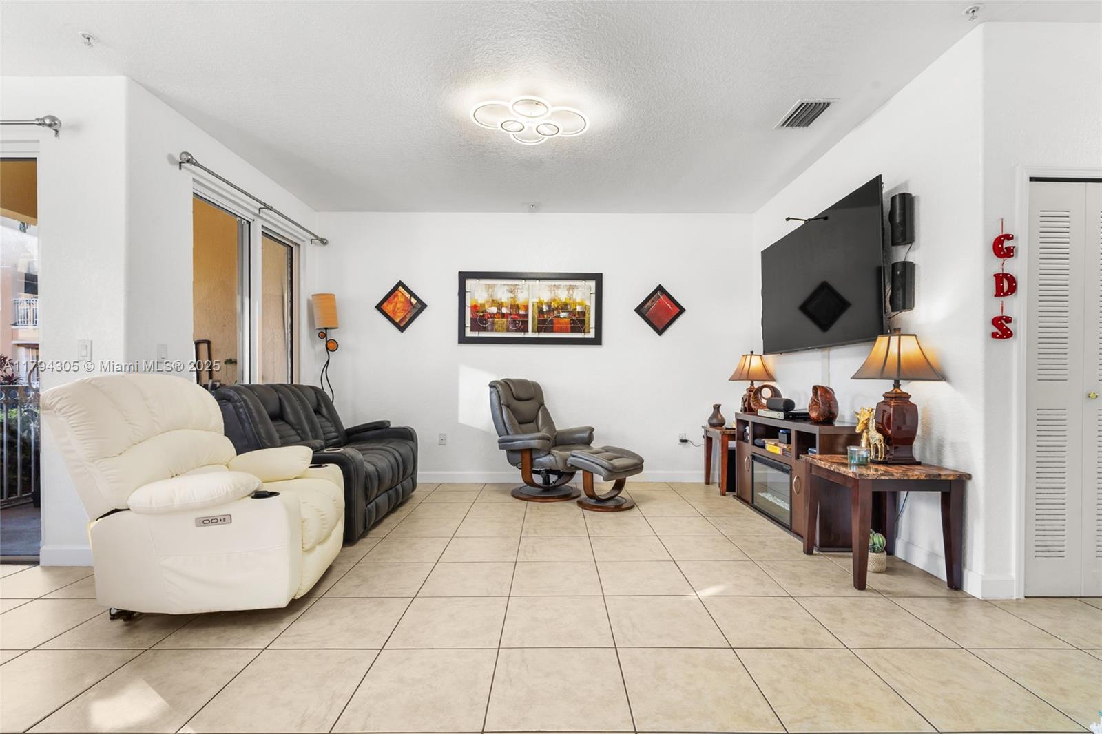 10012 Northwest 7th Street, Unit 107 Miami, FL 33172 - Photo 10 of 44 a living room with furniture and a flat screen tv