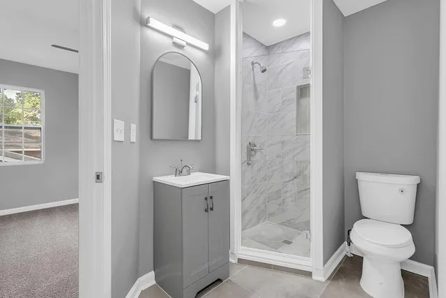 a bathroom with a toilet sink and shower