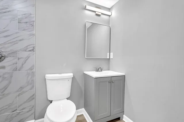 a white toilet sitting next to a bathroom sink