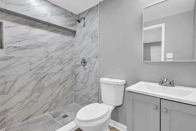 a white toilet sitting next to a bathroom sink