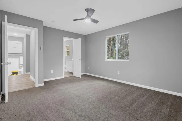 an empty room with windows and closet