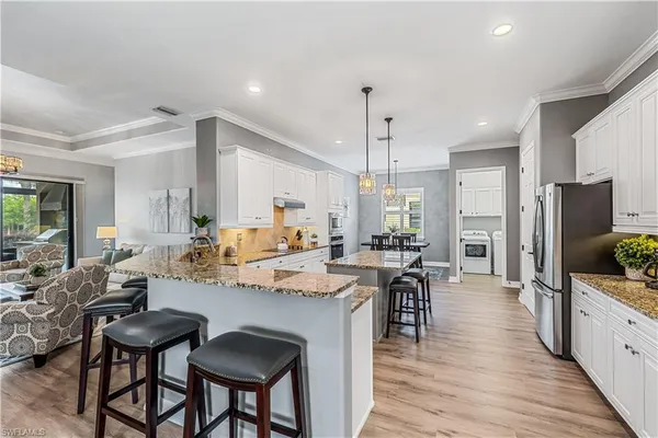 a large kitchen with a table and chairs
