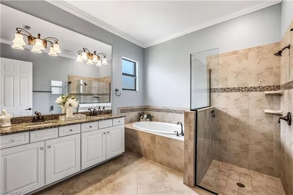 a spacious bathroom with a double vanity sink a mirror and a shower