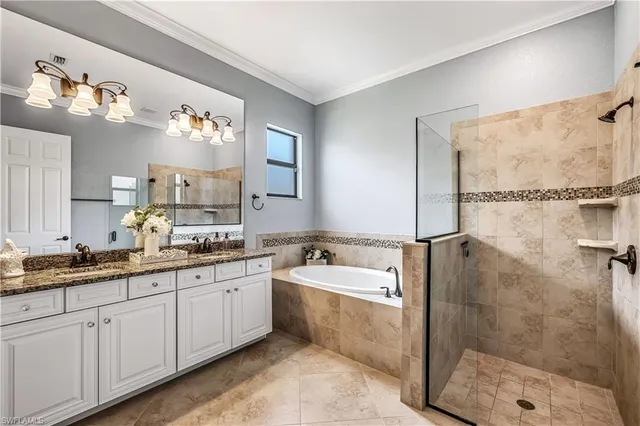 a spacious bathroom with a double vanity sink a mirror and a shower