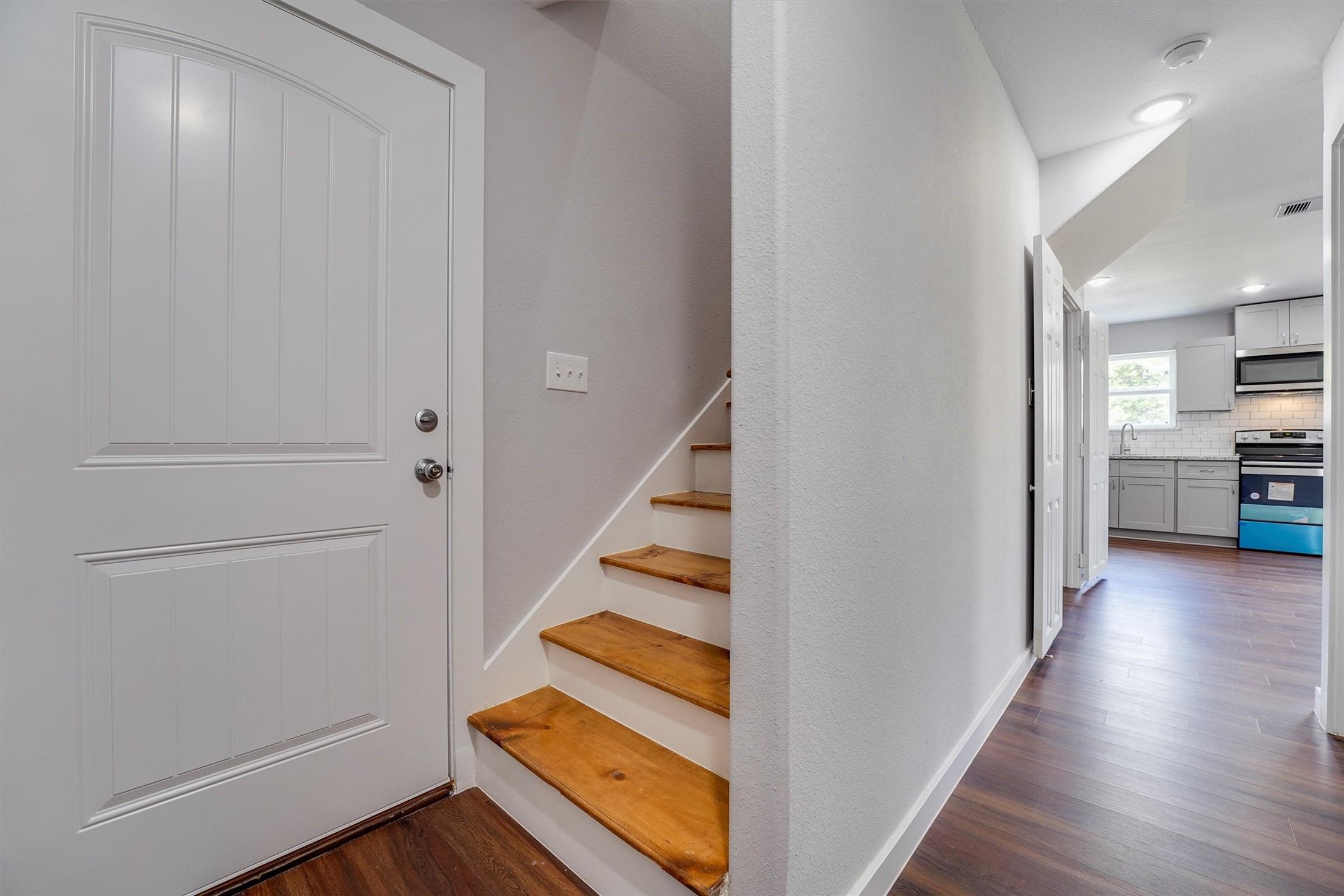 6716 Haight Street, Unit A Houston, TX 77028 - Photo 3 of 14 a view of a kitchen with wooden floor and a kitchen