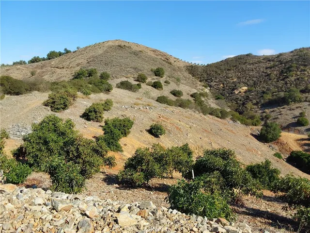 a view of a large mountain with mountains in the background