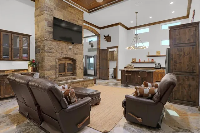 a living room with fireplace furniture and a flat screen tv