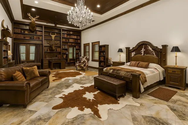 a bedroom with a bed couch and chandelier