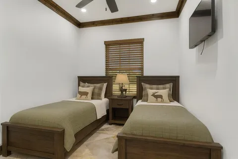 a bedroom with two beds and a night stand