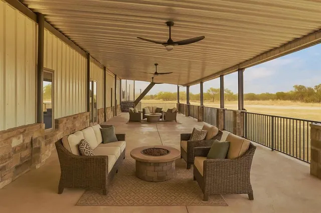 a view of a patio with couches chairs and wooden floor