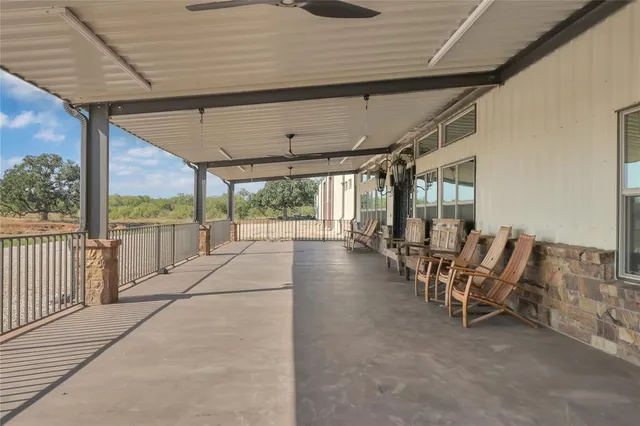 a view of a patio with table and chairs