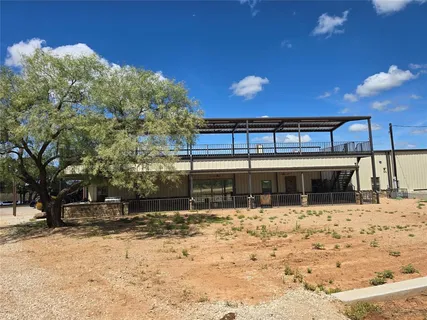 a view of a house with snow on the road
