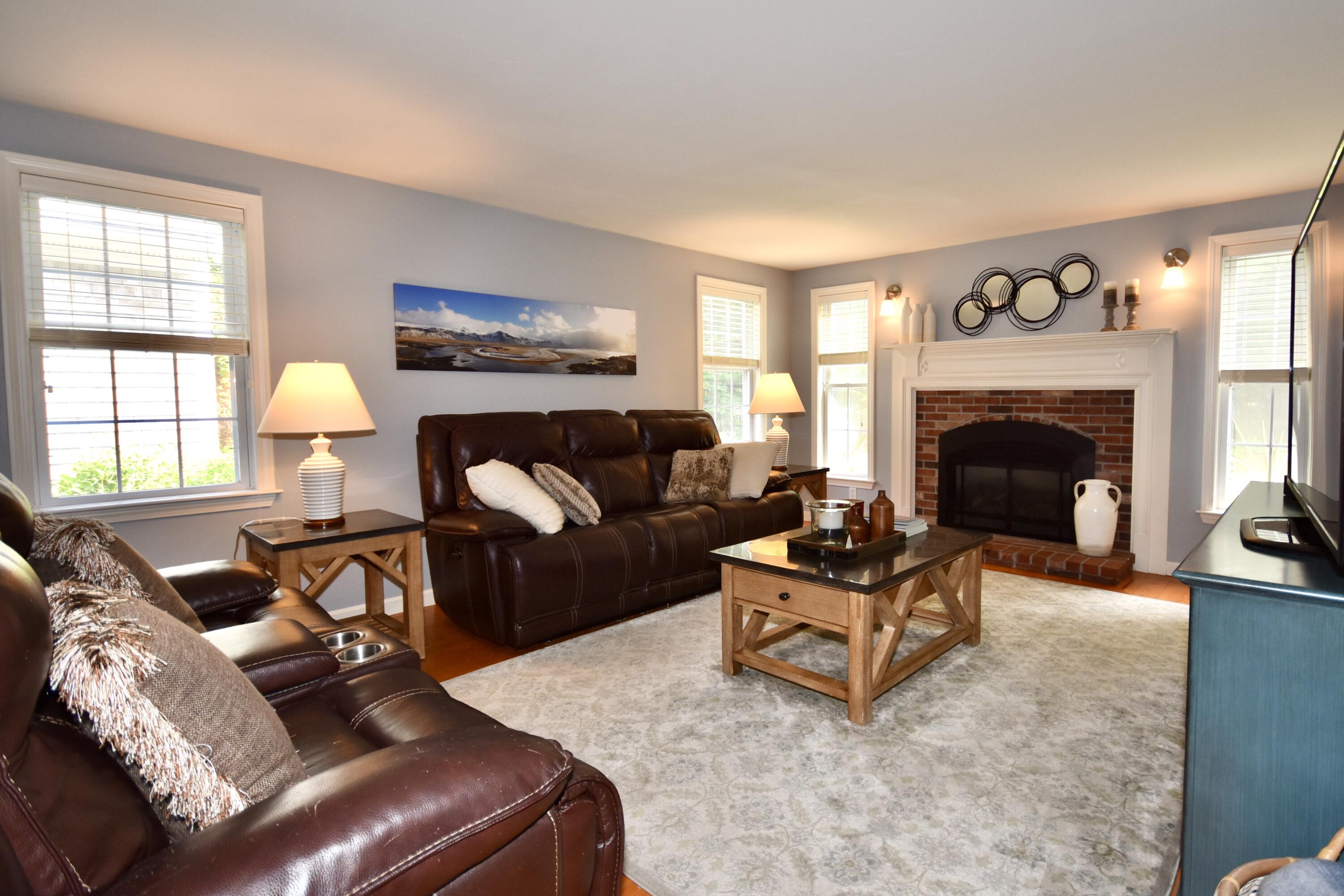 33 Asa Meiggs Road Sandwich, MA 02563 - Photo 18 of 34 a living room with furniture and a fireplace