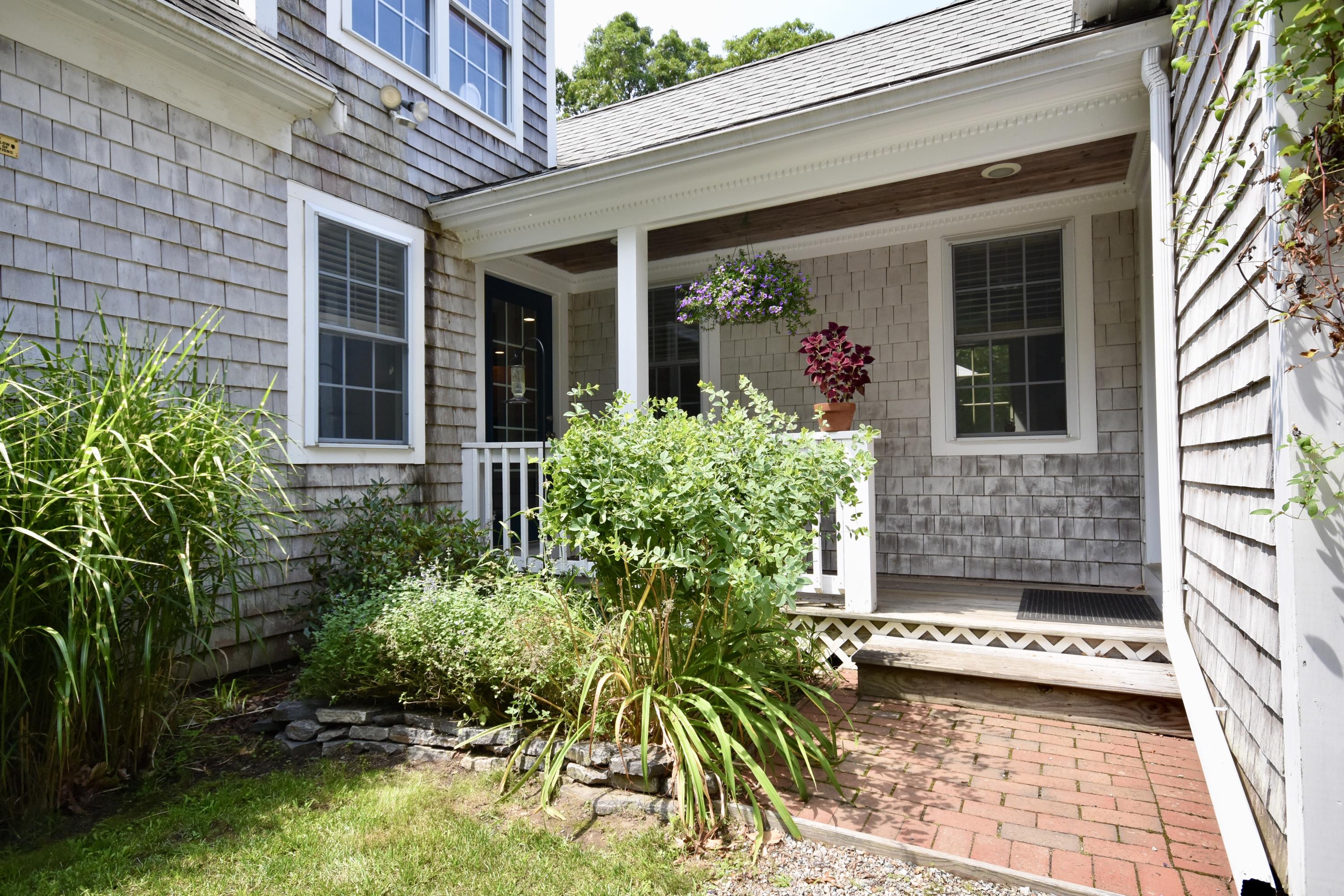 33 Asa Meiggs Road Sandwich, MA 02563 - Photo 3 of 34 a front view of a house with a yard