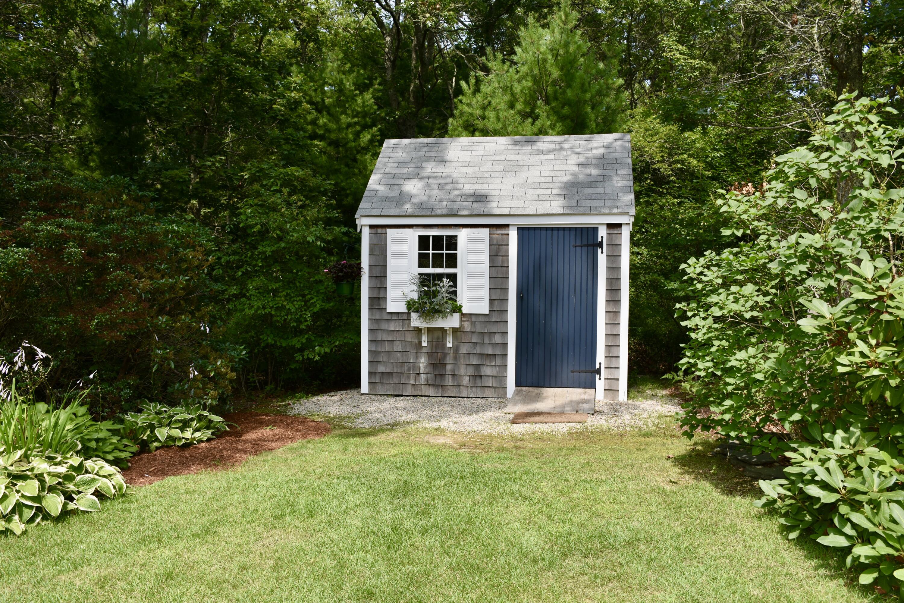 33 Asa Meiggs Road Sandwich, MA 02563 - Photo 10 of 34 front view of a house with a garden