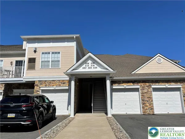 a view of a house with car parked