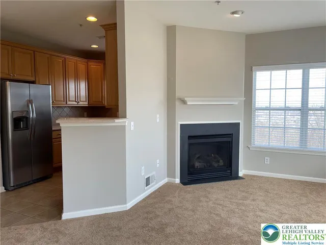 a living room with a fireplace and a rug