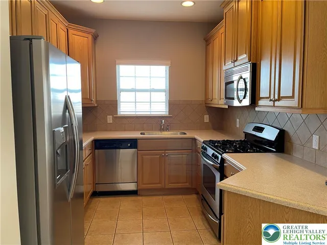 a kitchen with a refrigerator and a sink