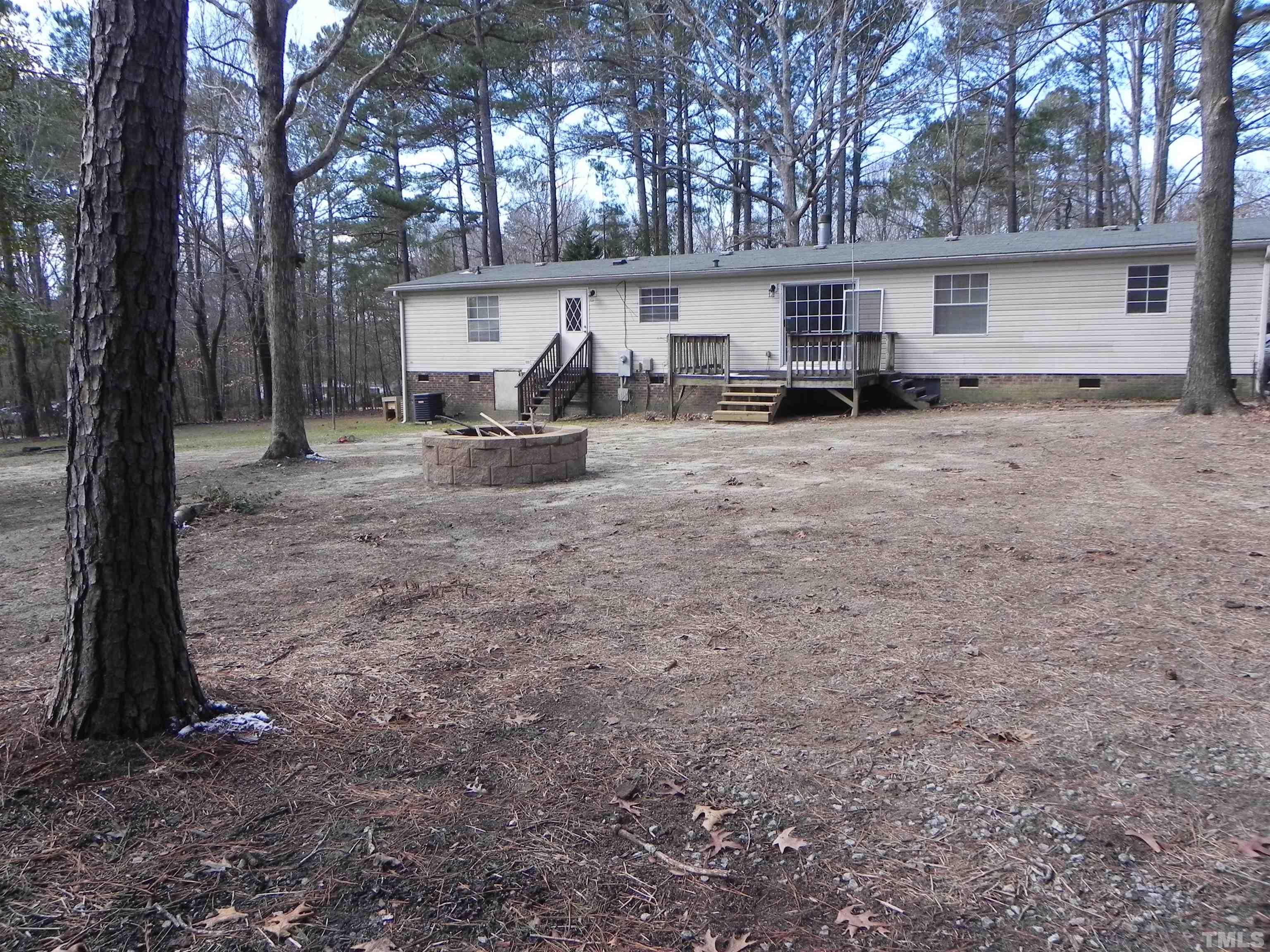 8413 South Creek Road Willow Spring, NC 27592 - Photo 3 of 31 a view of a house with backyard and a tree