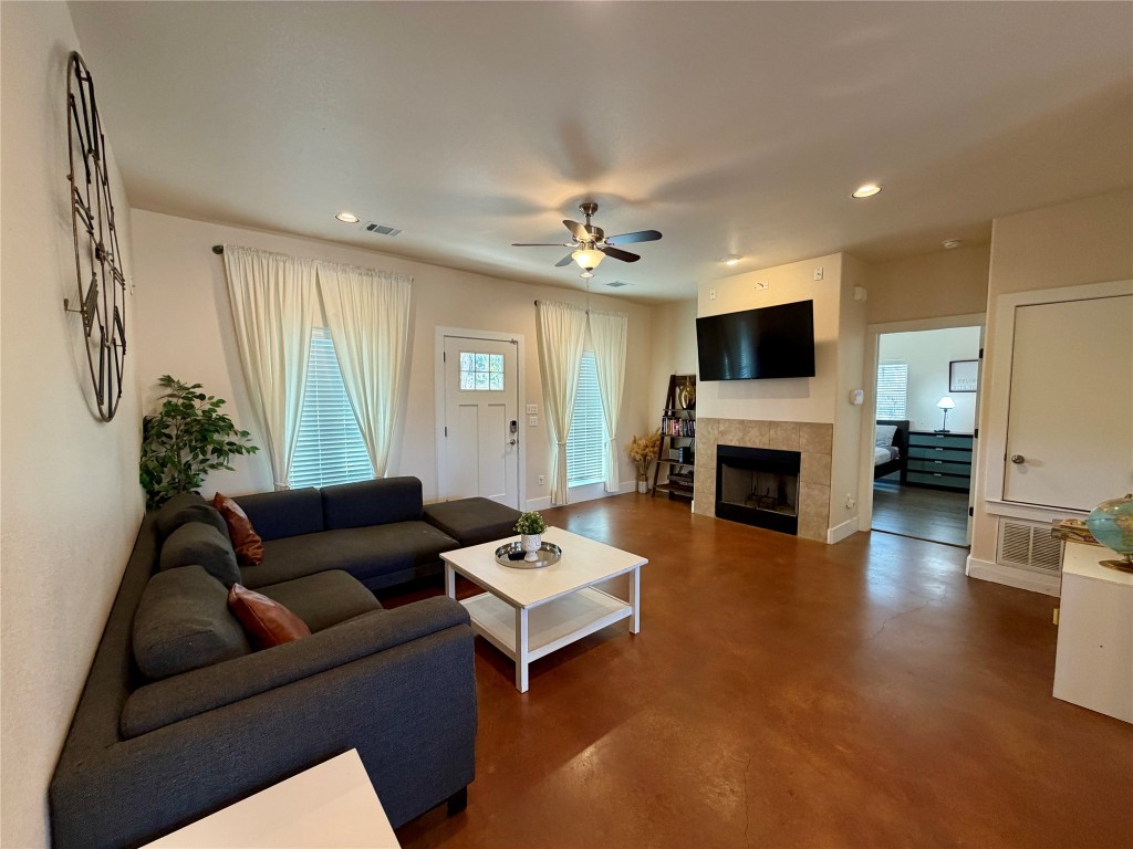 5503 Hiline Road Austin, TX 78734 - Photo 2 of 20 Living area featuring concrete floors, recessed lighting, a tile fireplace, and ceiling fan