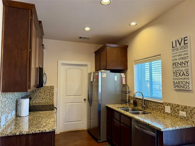 a kitchen with a sink stove and refrigerator