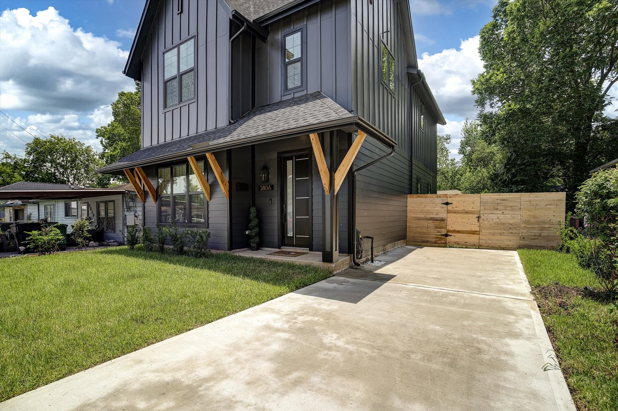 3806 Dreyfus Street Houston, TX 77021 - Photo 2 of 48 Modern farmhouse exterior featuring custom cedar posts and fencing with a gate on each side.