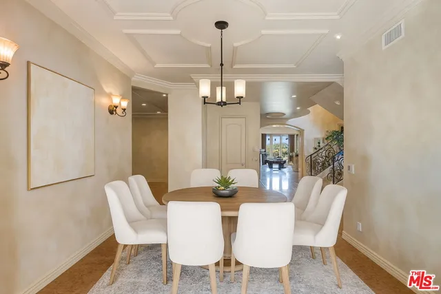 a view of a dining room with furniture wooden floor and chandelier