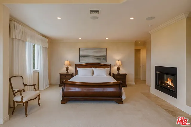 a spacious bedroom with a bed and a fireplace