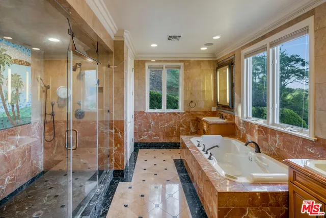 a large spacious bathroom with a tub shower and sink