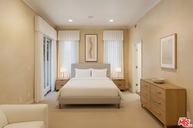 a spacious bedroom with a bed and a couch