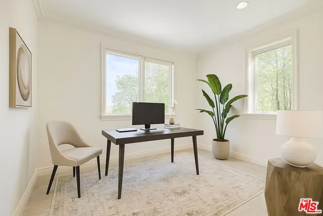 a view of a livingroom with workspace and a window