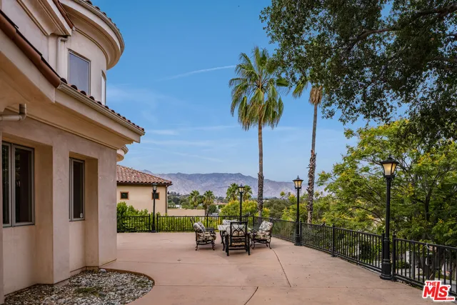a view of a patio with a table and chairs