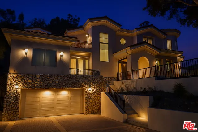 a front view of a house with lots of lights