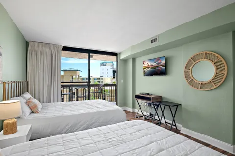 a bedroom with a bed a mirror and a window