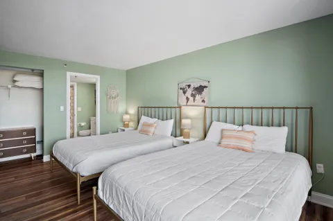 a bedroom with a bed and a night stand