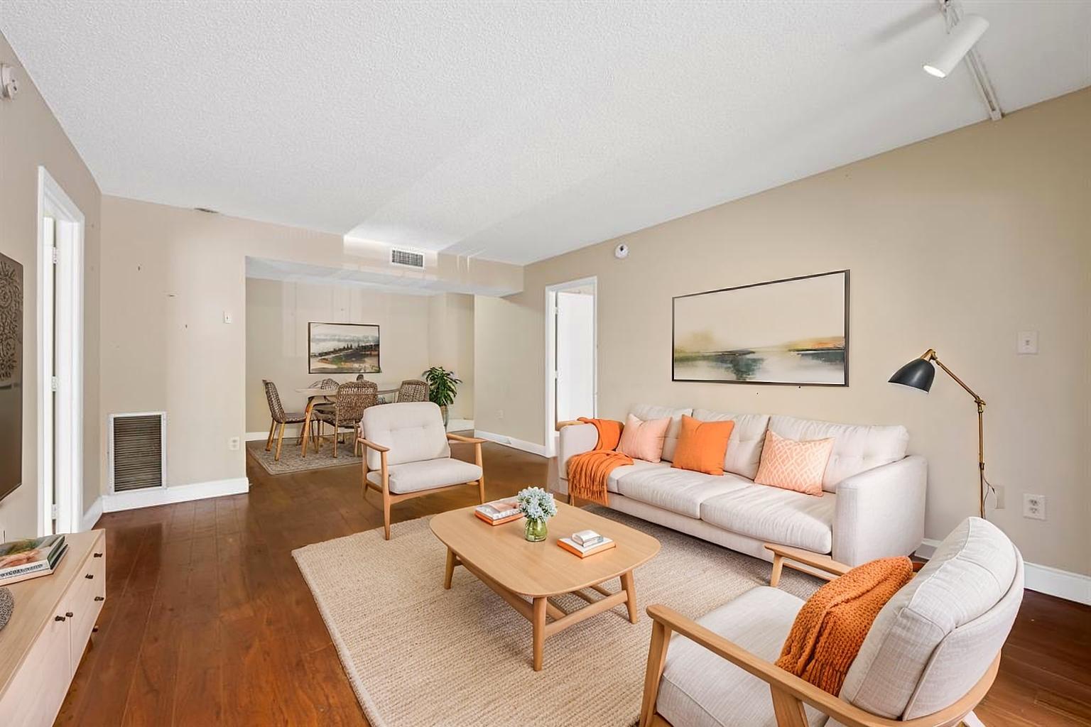 4156 Inverrary Drive, Unit 210 Lauderhill, FL 33319 - Photo 18 of 27 a living room with furniture a fireplace and a table