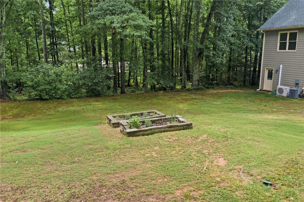 4891 Bill Cheek Road Auburn, GA 30011 - Photo 63 of 99 a view of a swimming pool with an outdoor space and seating area