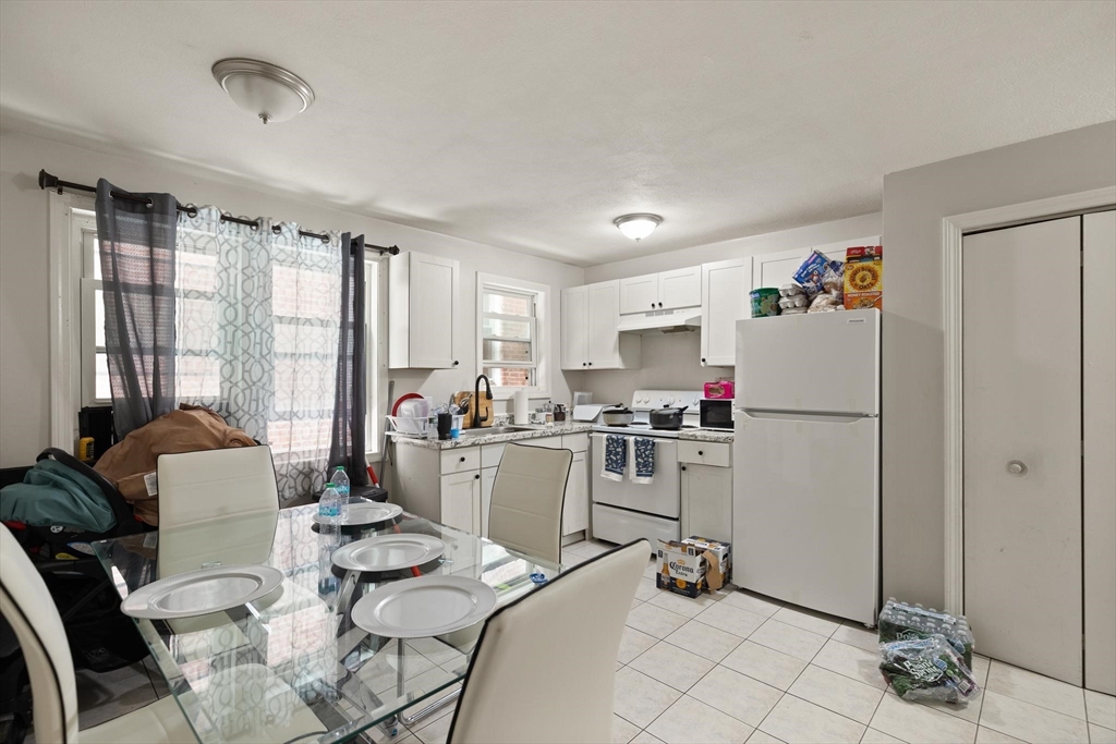 138 Franklin Street Lynn, MA 01902 - Photo 2 of 13 a room with furniture a flat screen tv and a window