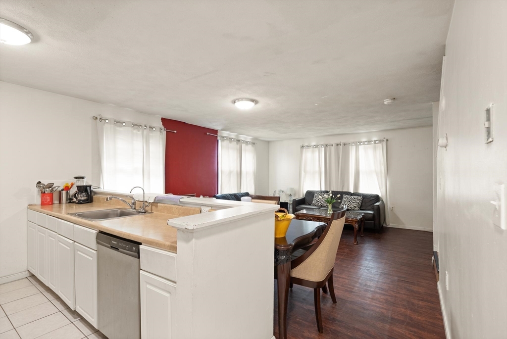 138 Franklin Street Lynn, MA 01902 - Photo 3 of 13 a kitchen that has a sink and chairs in it