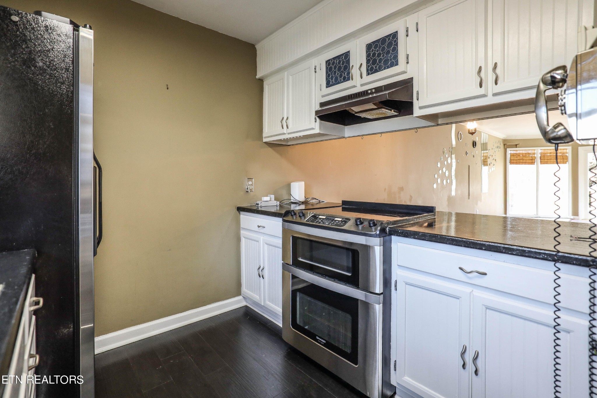 1340 Windamere Road Knoxville, TN 37923 - Photo 19 of 53 a kitchen with stainless steel appliances white cabinets and a stove top oven