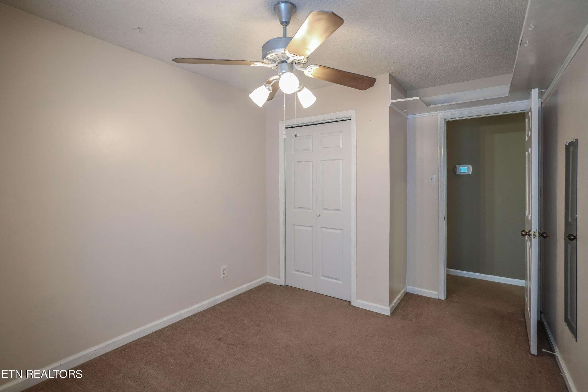 1340 Windamere Road Knoxville, TN 37923 - Photo 28 of 53 an empty room with a chandelier fan and a window