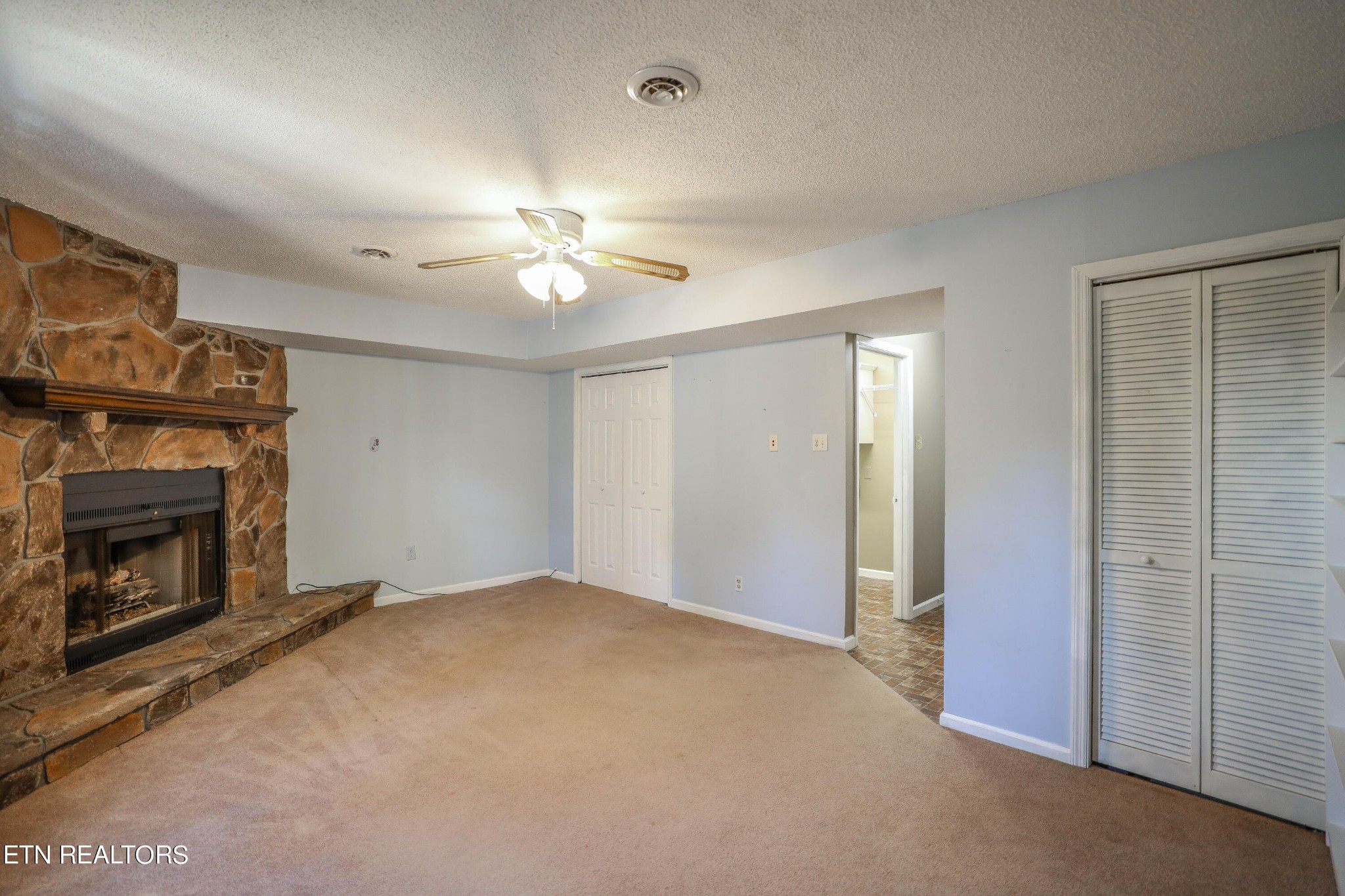 1340 Windamere Road Knoxville, TN 37923 - Photo 46 of 53 a view of an empty room with chandelier fan and fire place