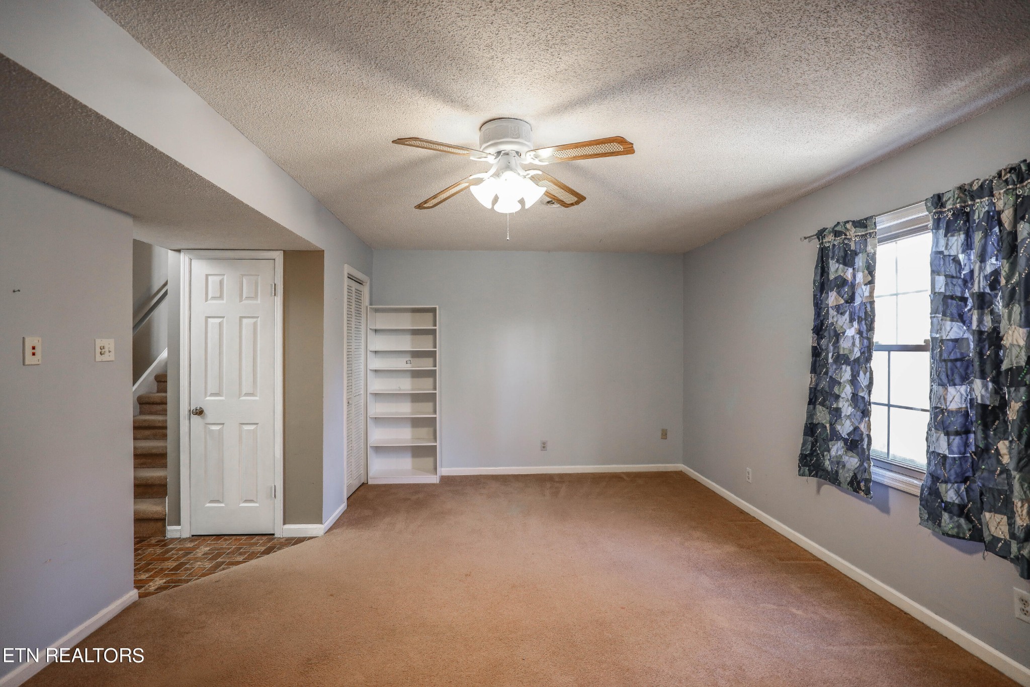 1340 Windamere Road Knoxville, TN 37923 - Photo 48 of 53 an empty room with closet and chandelier fan
