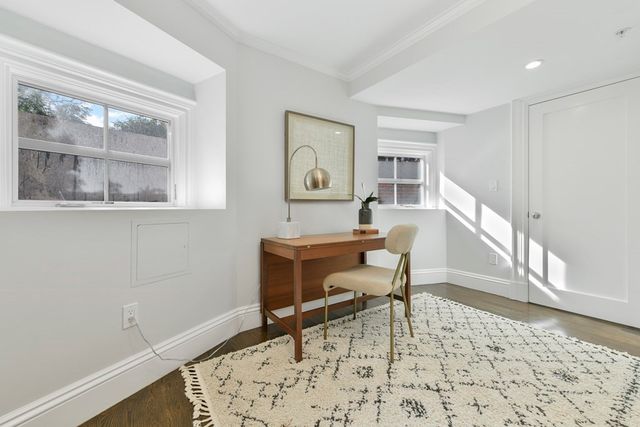 a workspace with wooden floor and a window