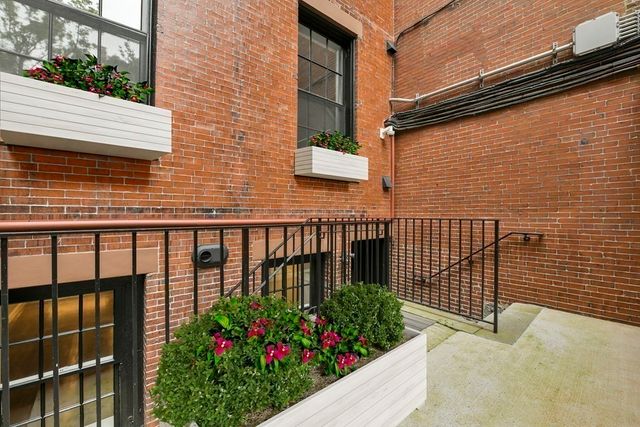 a view of a pathway of a house with a flower garden