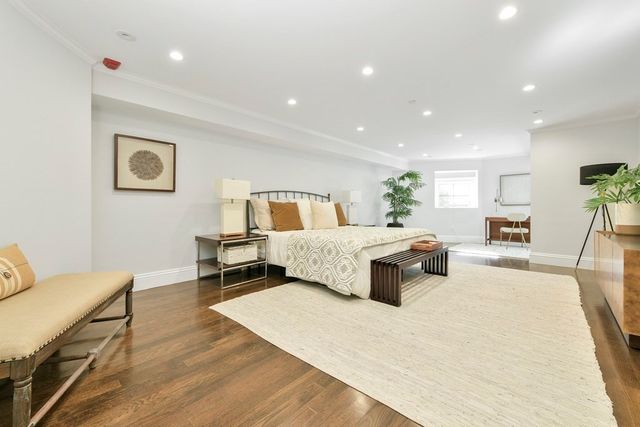 a bedroom with a large bed and a couch