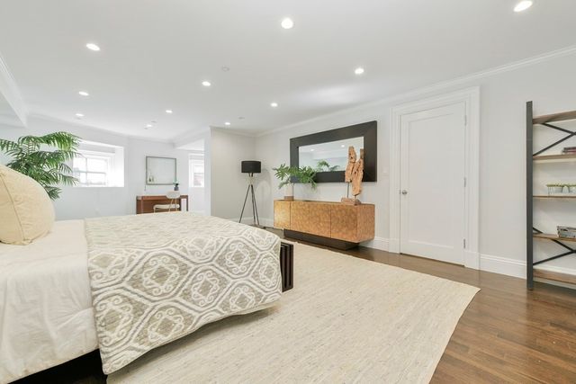 a bed room with a bed and a large window