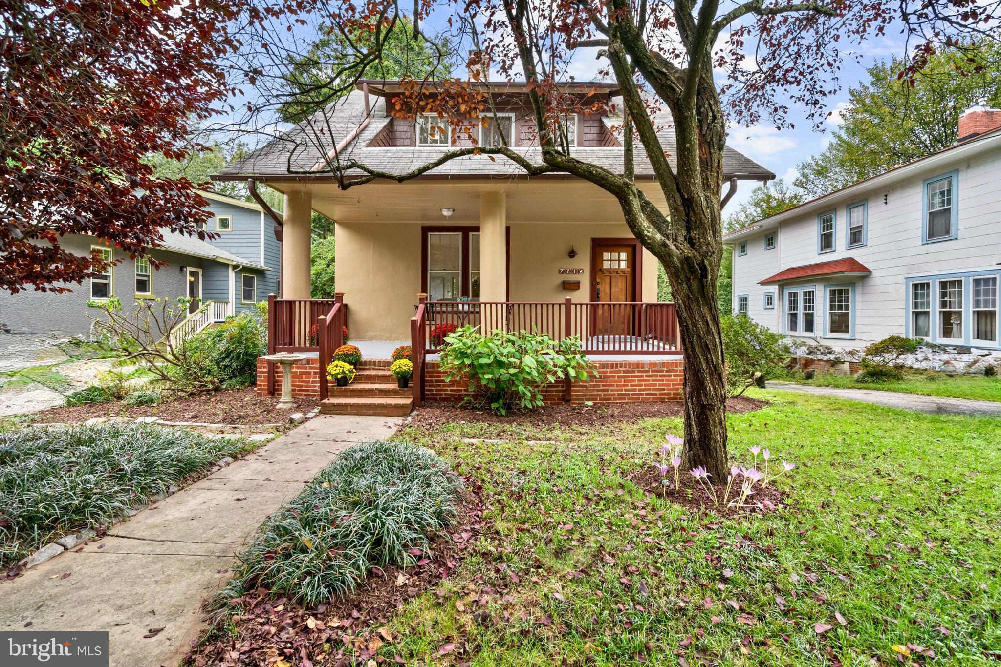 Charming home with inviting porch and greenery.