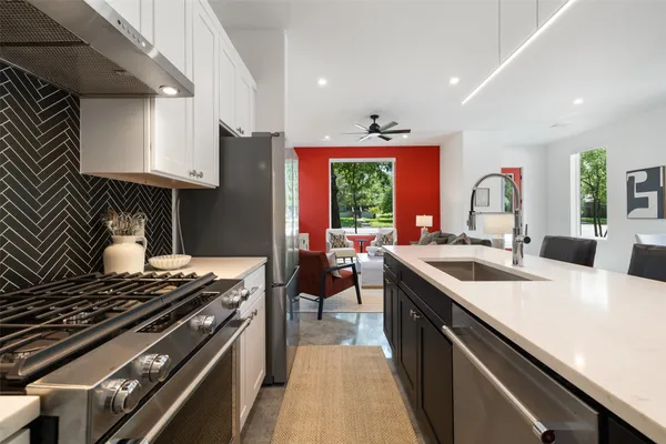 a kitchen with a stove and a sink