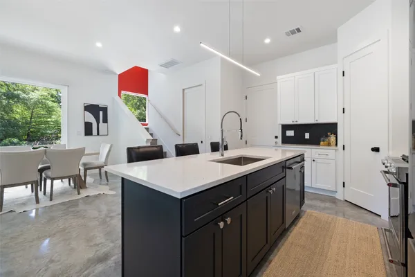 a kitchen with a sink cabinets and wooden floor